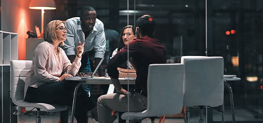 A group of employees discussing their AI fabric and AI integration strategy.