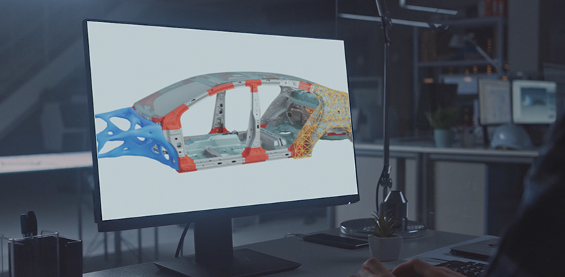 An engineer works on the skeleton model of a body-in-white in finite element modeling software.