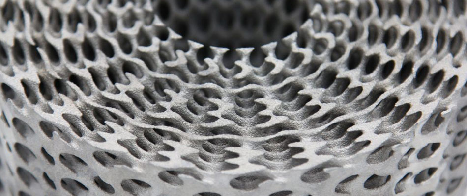 Complex lattice structure produced using a hybrid production method combining additive manufacturing and traditional casting.