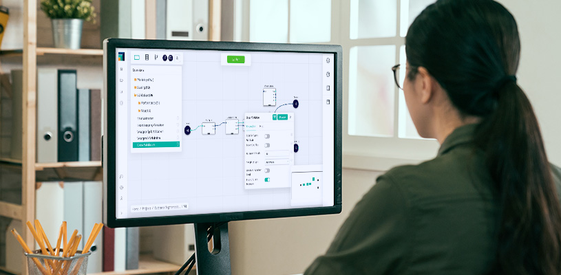 A female engineer uses Altair software to test and validate a complex AI workflow in the development environment before deploying the workflow on the production server.