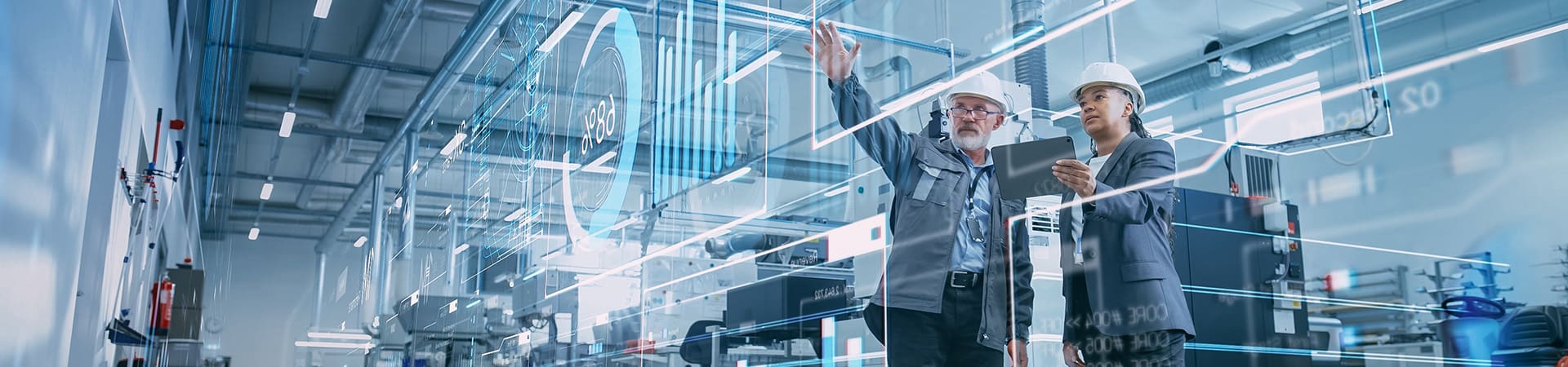 Two techs holding a tablet and using AI agents on manufacturing line.