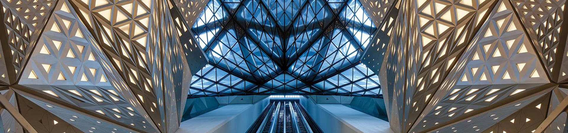 Interior view of a building showcasing a large metal structure, highlighting modern architectural design elements.