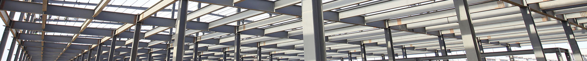 An expansive steel building with multiple beams and windows, exemplifying modern architectural efficiency.