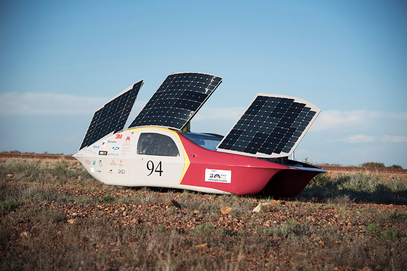 An image of Soukup's solar vehicle with its solar panels outstretched on its roof.
