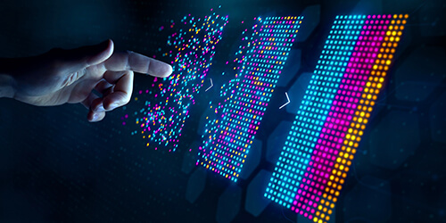 Hand with finger pointing at a screen with colorful points representing data.