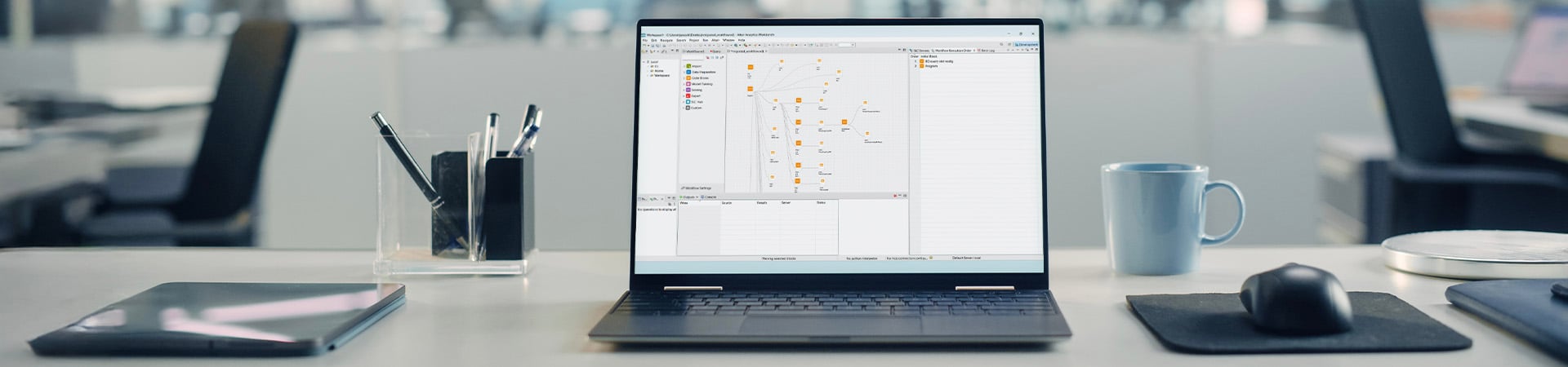 A laptop computer displays the visual user interface for Altair's SAS language coding environment, which can compile SAS, Python, and R code in any combination.