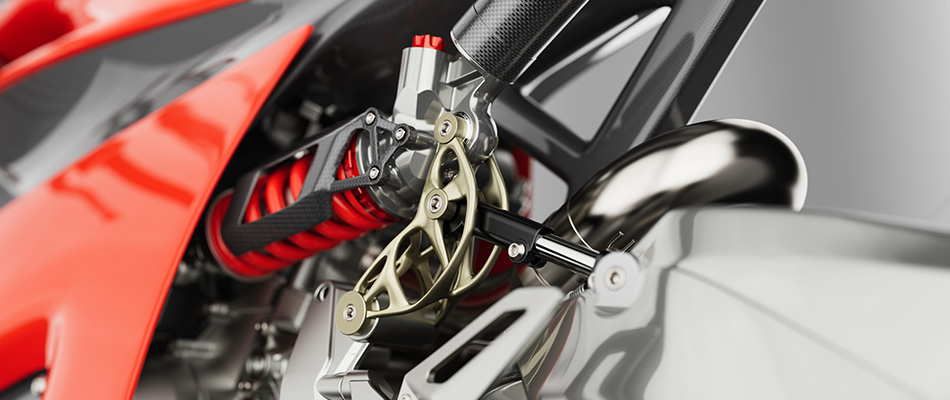 Image shows a motorcycle suspension comprising an additive manufactured metal component made by 3D printing process.