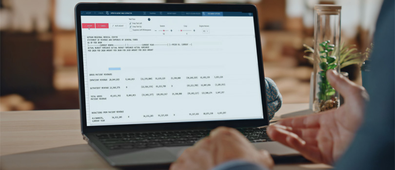 A male business user with a laptop displaying the deployment tools built into Altair Monarch Server ETL automation and report warehousing software.