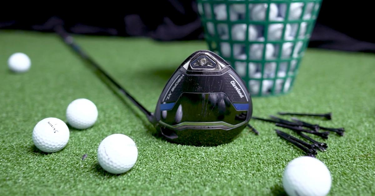 Displaying a Cleveland Golf HiBore XL Driver and golf balls on a rich green surface, this image captures the essence of golf.